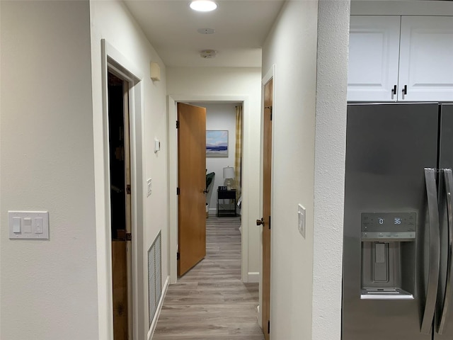 corridor featuring light hardwood / wood-style floors