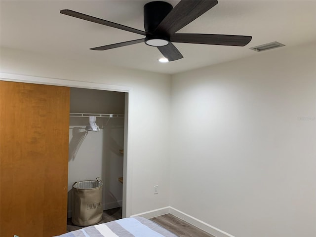 bedroom with a closet, ceiling fan, and hardwood / wood-style floors