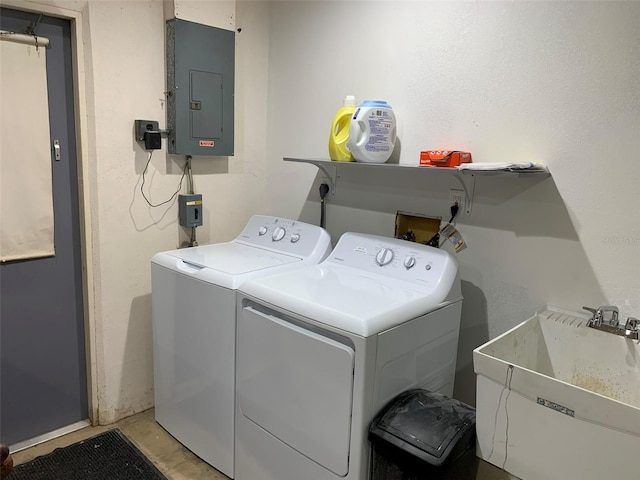 clothes washing area with electric panel, sink, and washing machine and clothes dryer