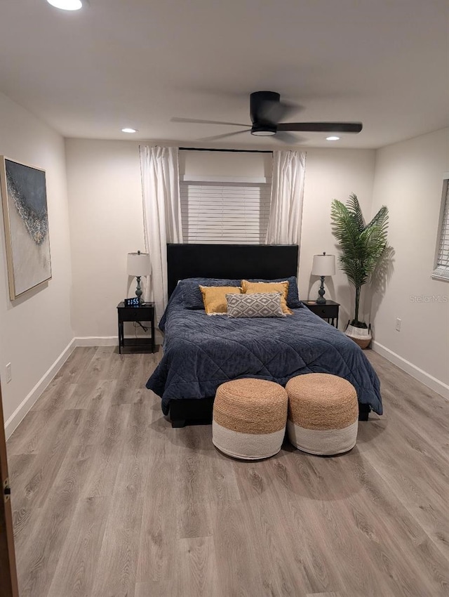 bedroom with ceiling fan and light hardwood / wood-style flooring