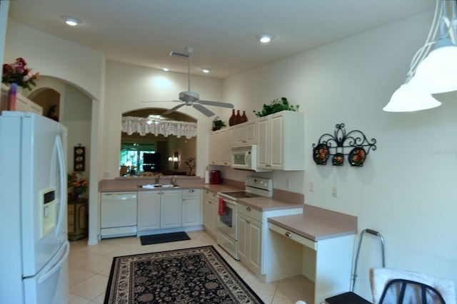 kitchen with light tile patterned flooring, ceiling fan, sink, and white appliances