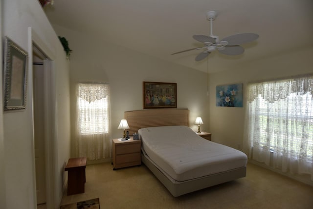 bedroom with light carpet, lofted ceiling, and ceiling fan