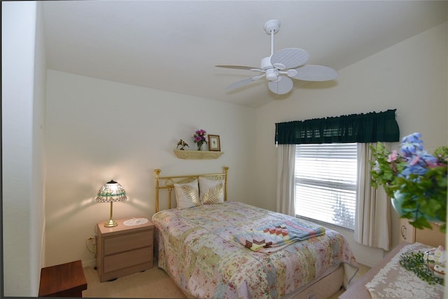 bedroom featuring light colored carpet and ceiling fan