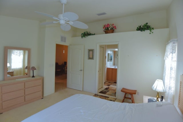 bedroom with ensuite bathroom and ceiling fan