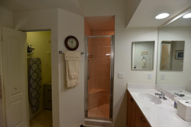 bathroom featuring vanity and a shower with shower door