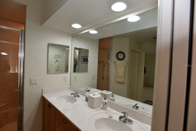 bathroom featuring vanity and an enclosed shower