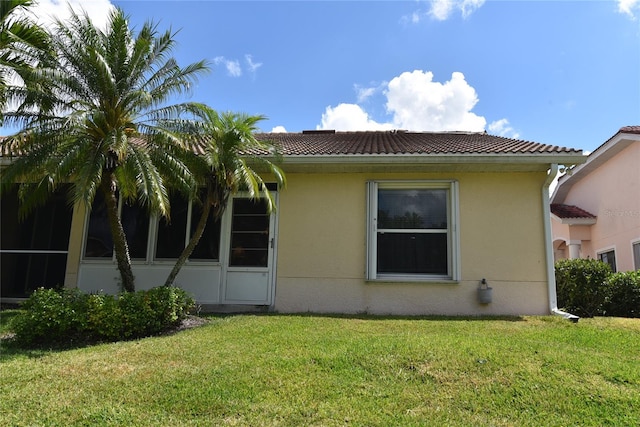 view of side of property with a yard