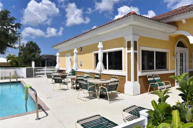 back of house featuring a patio and a fenced in pool