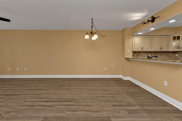 unfurnished dining area featuring a notable chandelier and hardwood / wood-style flooring