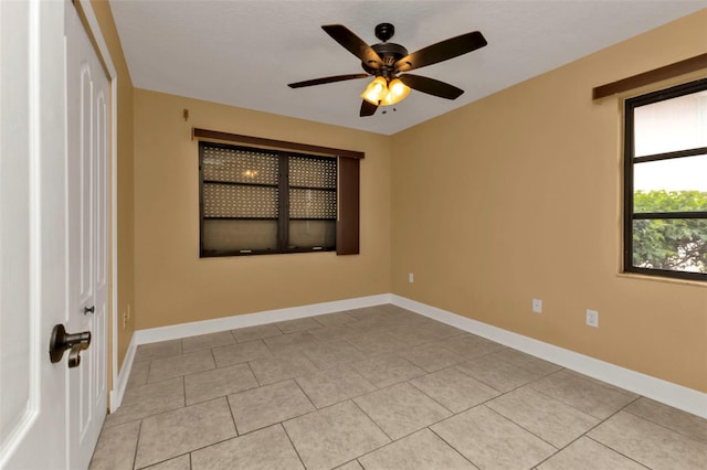 unfurnished room featuring light tile patterned floors and ceiling fan