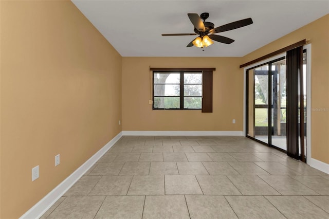 tiled spare room with ceiling fan