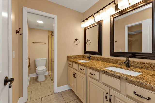 bathroom featuring vanity, toilet, tile patterned floors, and a shower