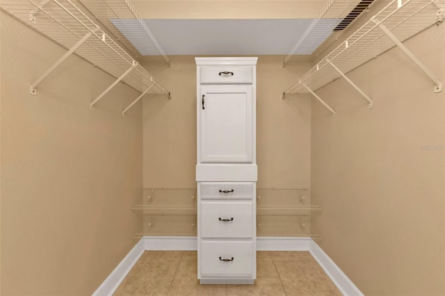 walk in closet featuring light tile patterned floors