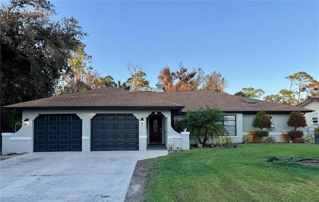 ranch-style house with a front yard and a garage