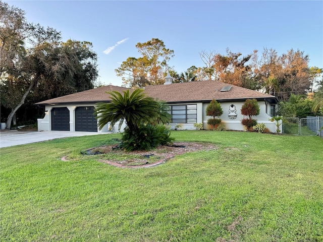 single story home with a garage and a front lawn