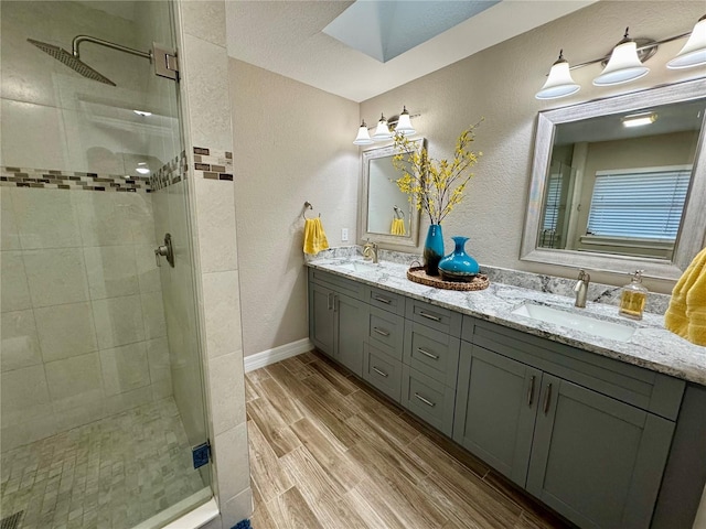 bathroom featuring vanity, hardwood / wood-style floors, and a shower with door