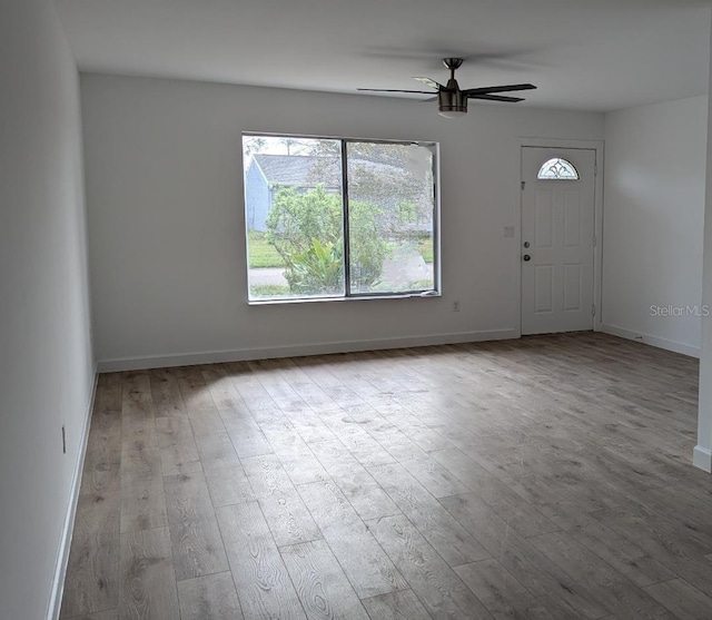 foyer with light hardwood / wood-style floors and ceiling fan