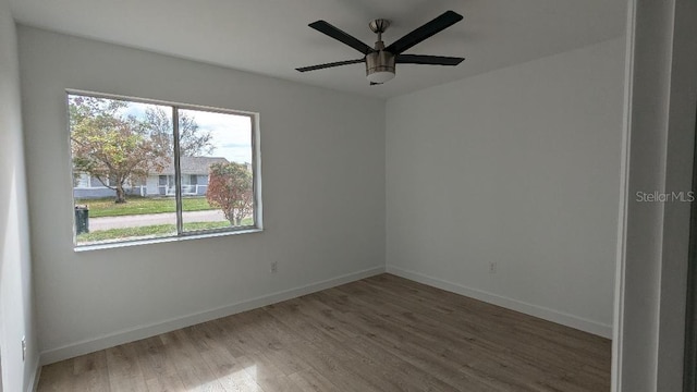 spare room with hardwood / wood-style floors and ceiling fan