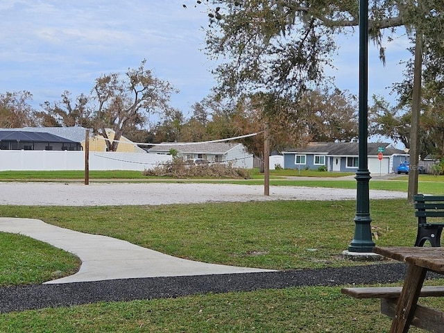 surrounding community featuring volleyball court and a yard