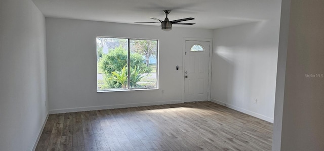 foyer entrance with light hardwood / wood-style floors and ceiling fan