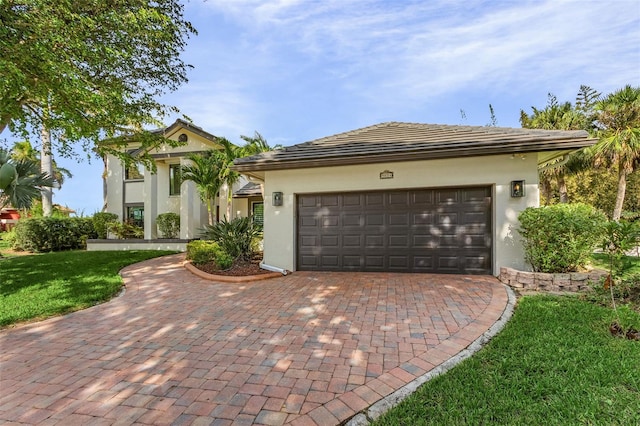 view of front of house with a garage and a front yard