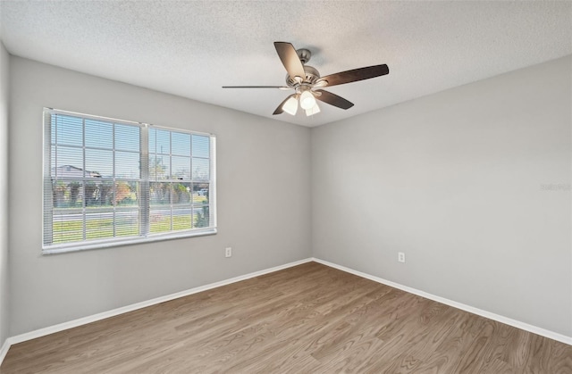 unfurnished room featuring ceiling fan, light hardwood / wood-style floors, and a textured ceiling