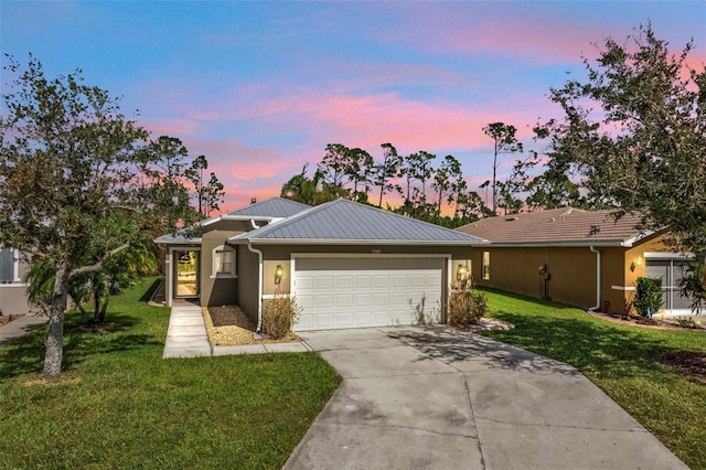 ranch-style house with a garage and a lawn