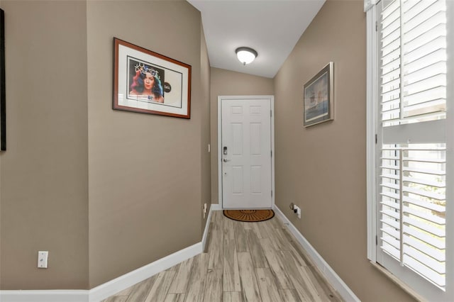 entryway featuring vaulted ceiling and light wood-type flooring