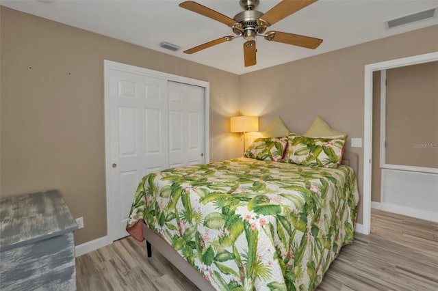 bedroom featuring light hardwood / wood-style flooring, a closet, and ceiling fan