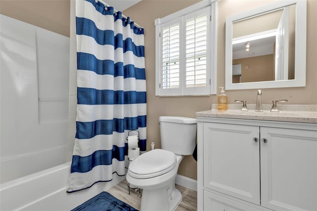 full bathroom with vanity, hardwood / wood-style floors, toilet, and shower / bathtub combination with curtain