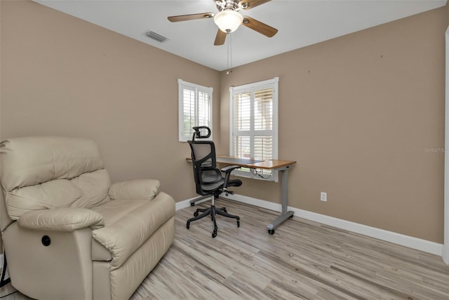 home office featuring light wood-type flooring and ceiling fan