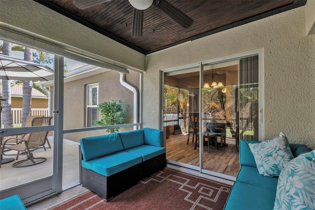 sunroom / solarium featuring ceiling fan and wooden ceiling