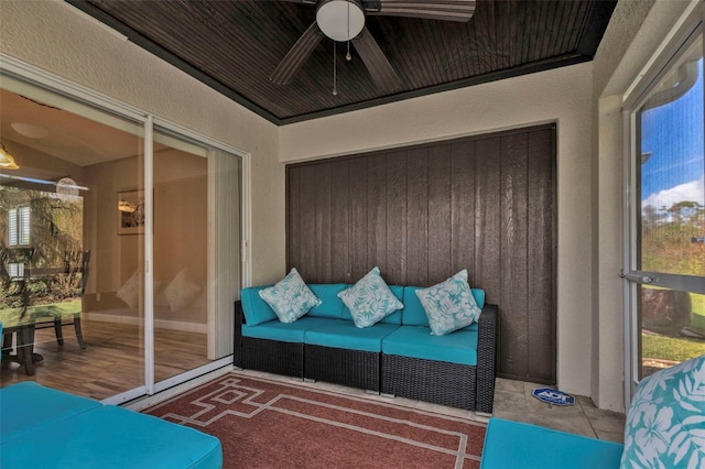 sunroom / solarium with wooden ceiling and ceiling fan