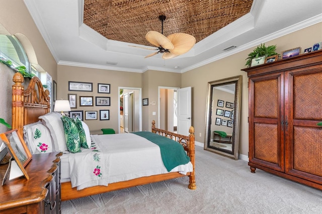 carpeted bedroom with ornamental molding, a raised ceiling, and ceiling fan