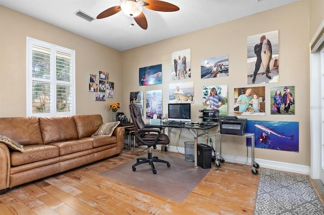 home office with hardwood / wood-style floors and ceiling fan