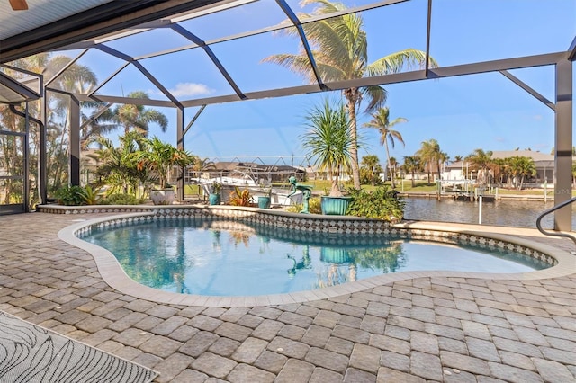 view of swimming pool with a patio area, a water view, and glass enclosure