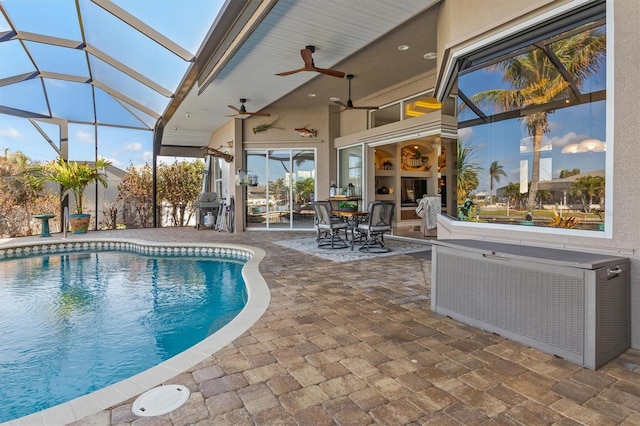 view of pool with a patio, ceiling fan, and a lanai