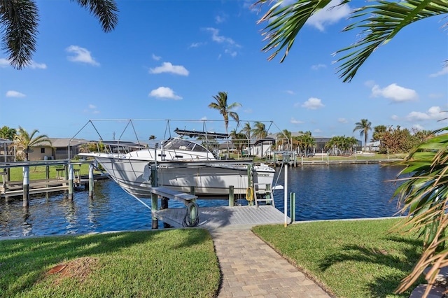 view of dock with a water view and a lawn