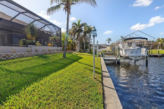 view of dock featuring a water view, a lanai, and a yard