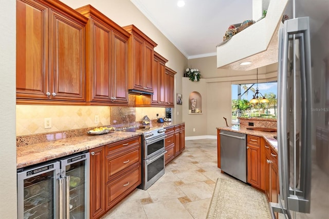 kitchen with ornamental molding, appliances with stainless steel finishes, light stone counters, and beverage cooler