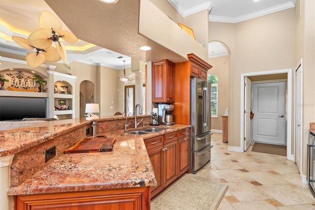 kitchen with built in shelves, ornamental molding, sink, and stainless steel fridge