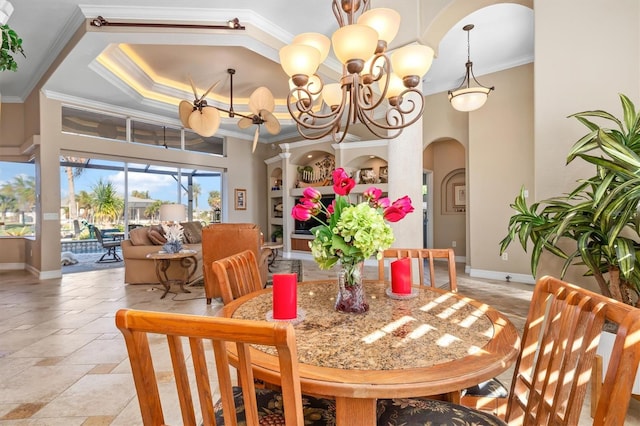 dining space featuring ornamental molding and an inviting chandelier