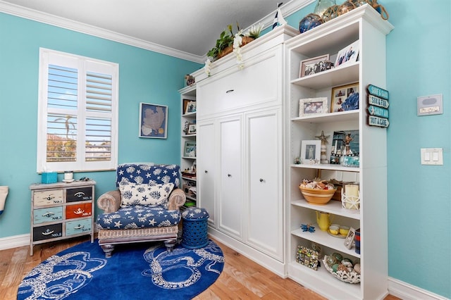 sitting room featuring crown molding and hardwood / wood-style floors