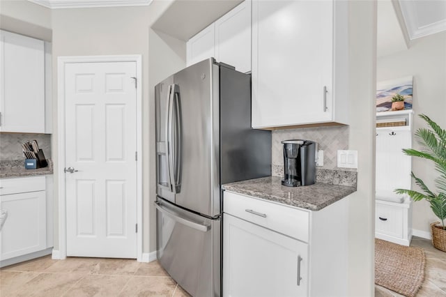 kitchen with ornamental molding, white cabinets, backsplash, and stainless steel fridge with ice dispenser