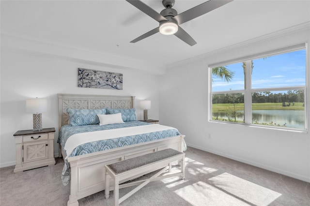 bedroom with a water view, ceiling fan, ornamental molding, and light colored carpet