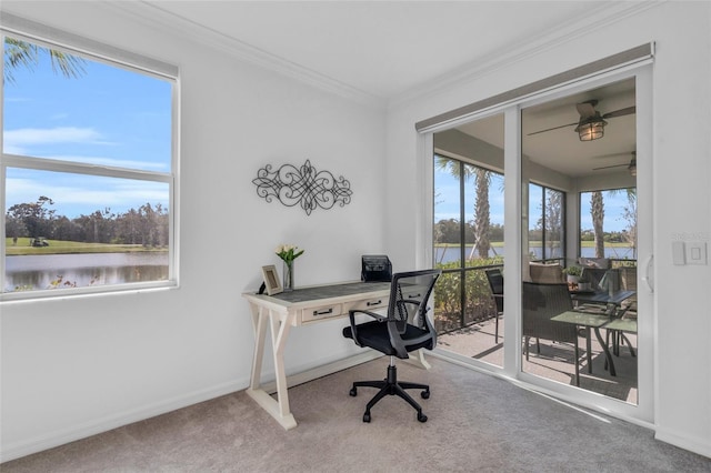 carpeted home office featuring ornamental molding, ceiling fan, a water view, and plenty of natural light