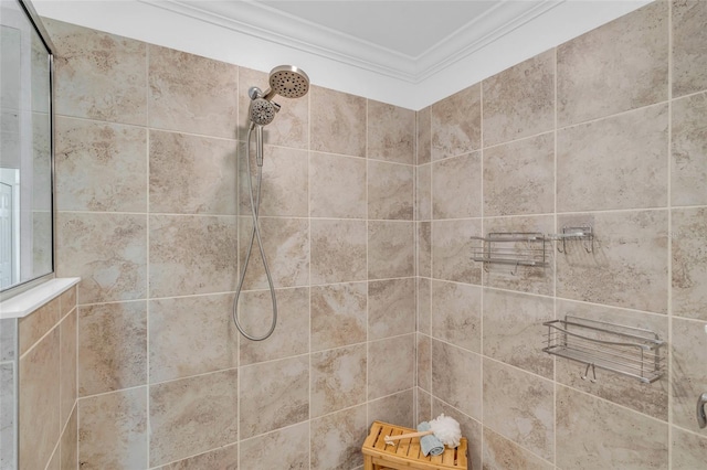 bathroom with a tile shower and ornamental molding