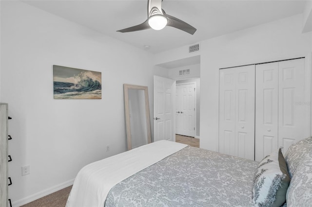 carpeted bedroom featuring a closet and ceiling fan