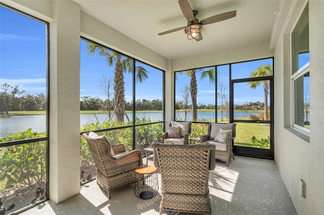 sunroom / solarium featuring a healthy amount of sunlight, a water view, and ceiling fan