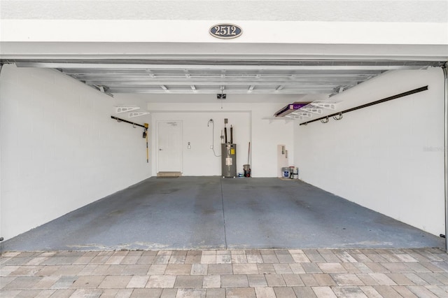 garage featuring a garage door opener and water heater